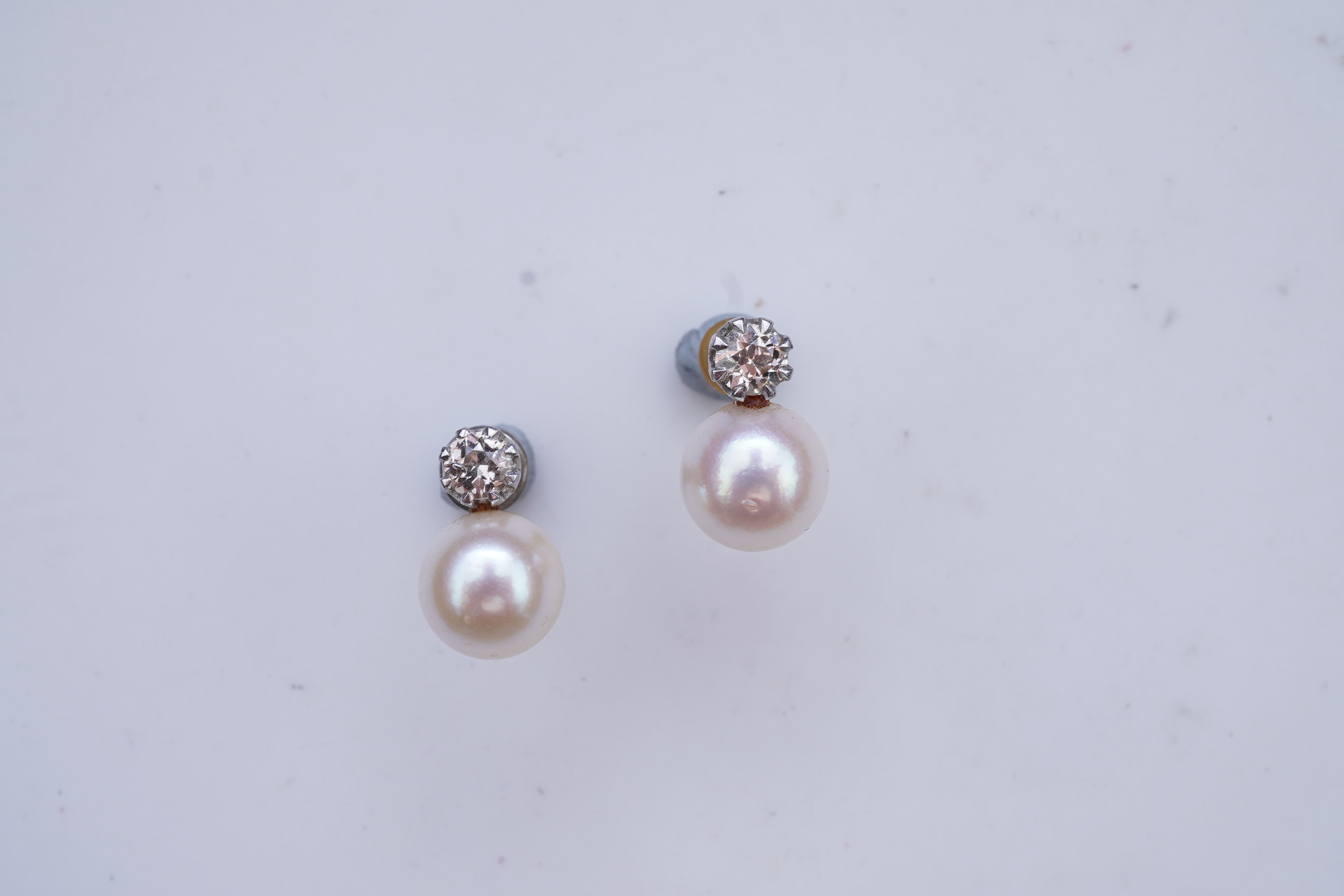 A pair of cultured pearl and diamond earrings